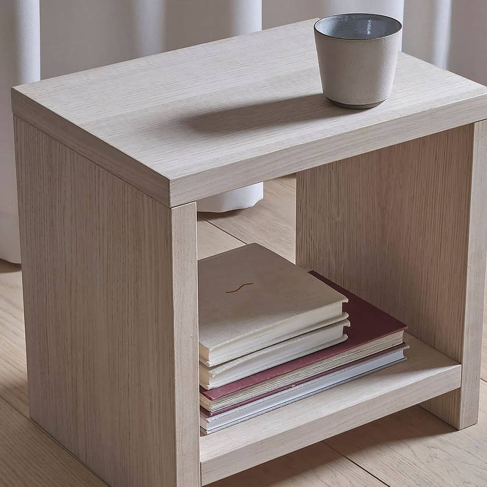 Gros plan sur la table de chevet cube Akva : placage bois clair, tasse posée sur le plateau